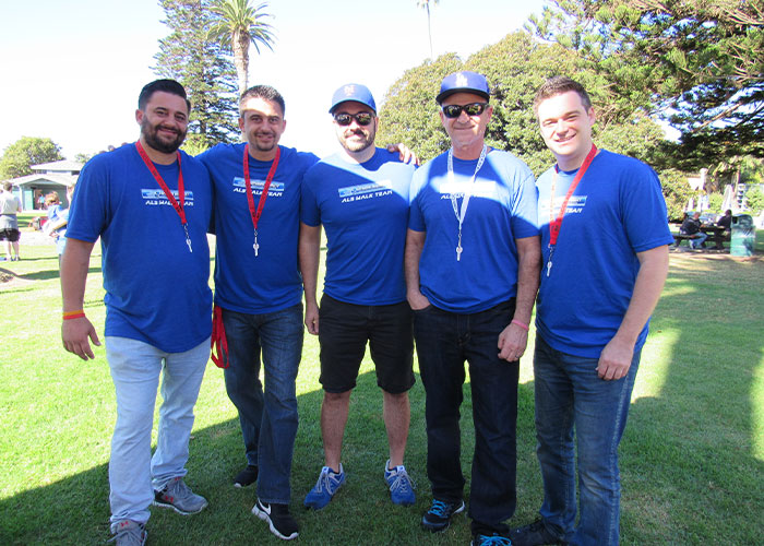 The team of Superior Mobility wearing Superior Mobility t-shirts outside.