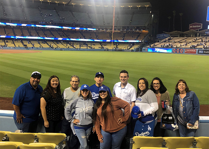 Employees all together at a sports arena.